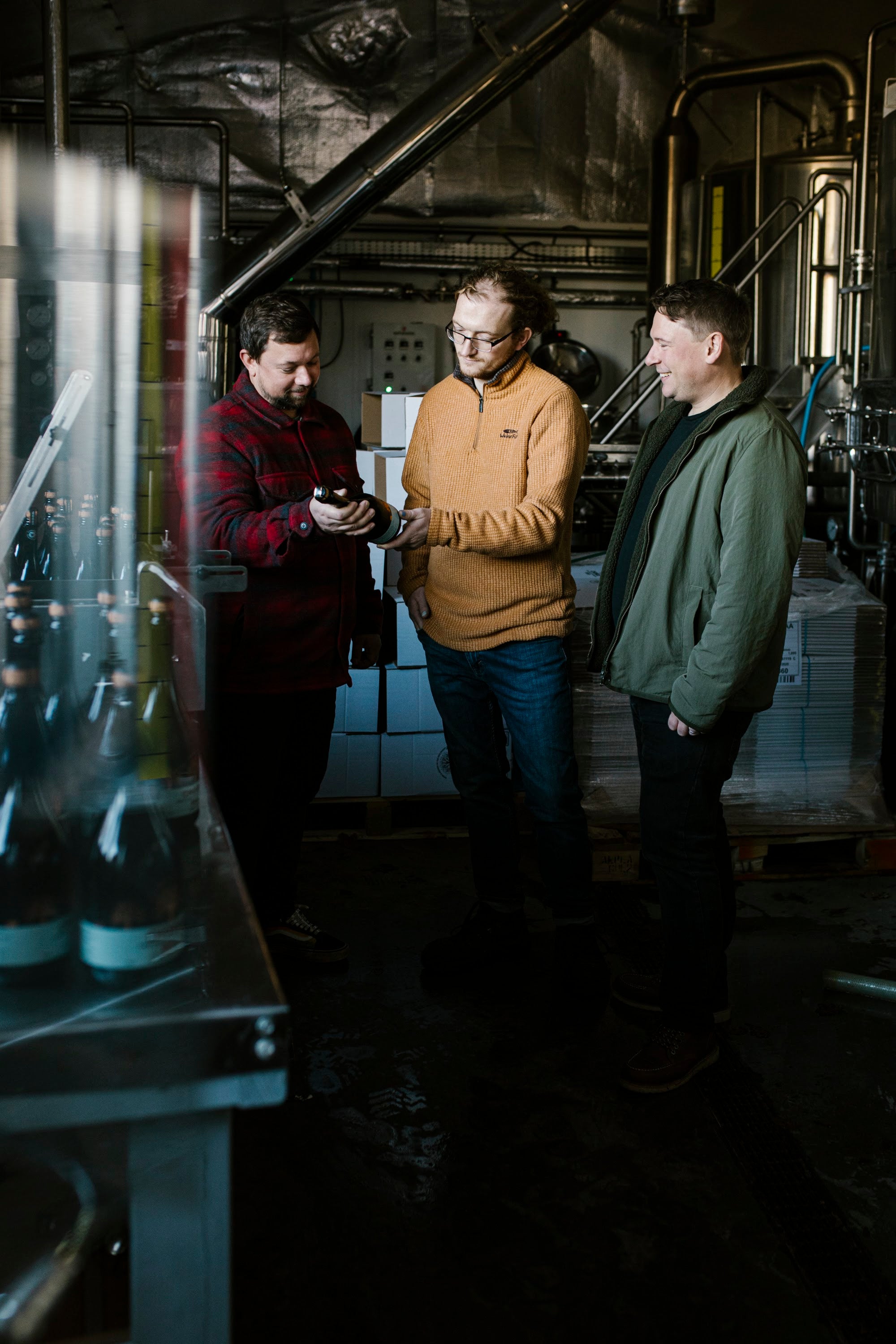 Tom, Lawrence and Harry Baynham at the bottling line, Baynhams Brewery