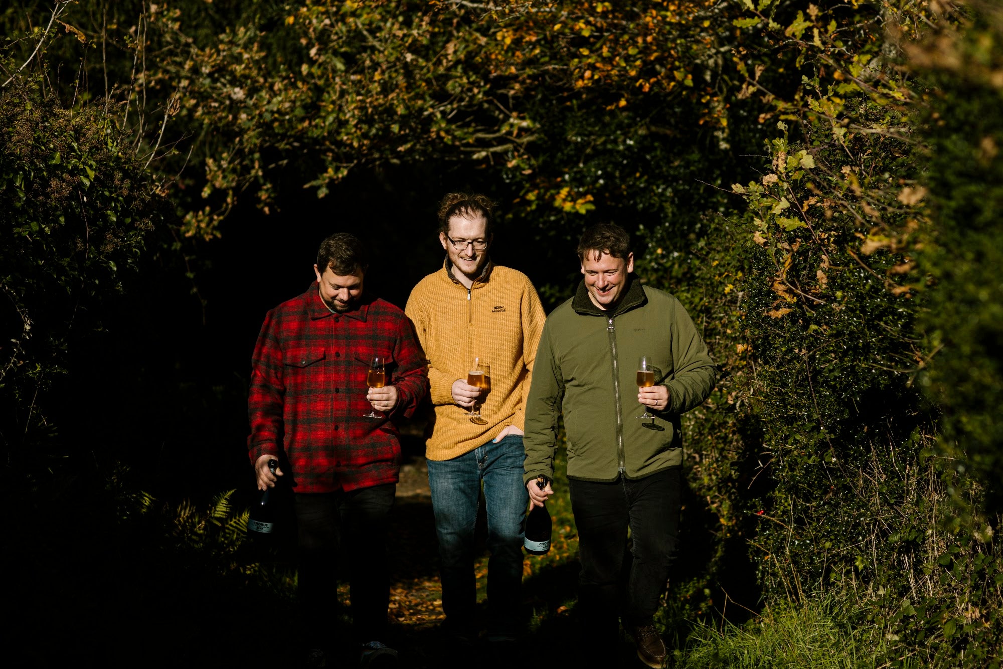 Tom, Lawrence and Harry Baynham walking in the New Forest with flutes of Chorus